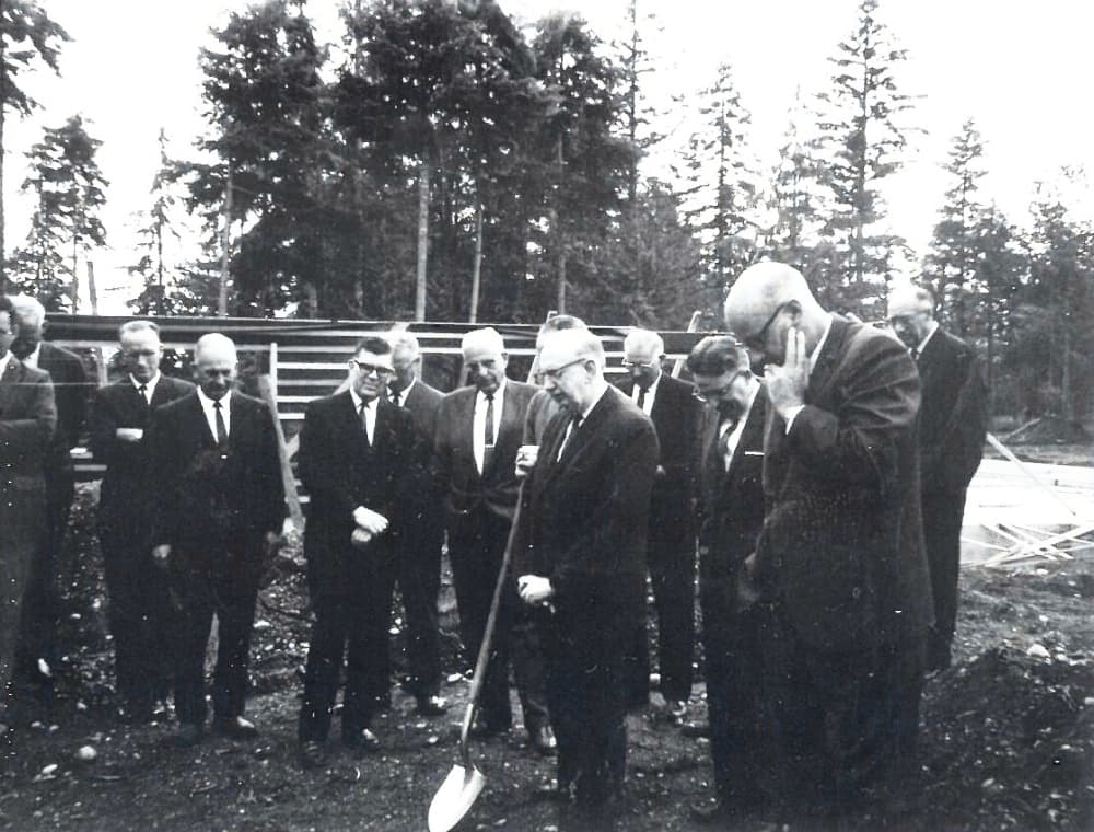Warm Beach founders bowing their heads in prayer at the Manor groundbreaking